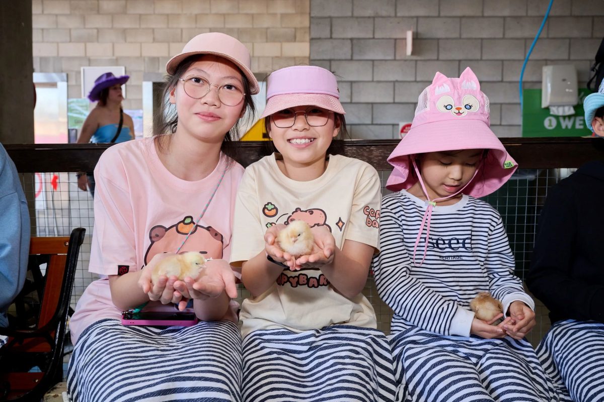 Family holding chickens at the Ekka