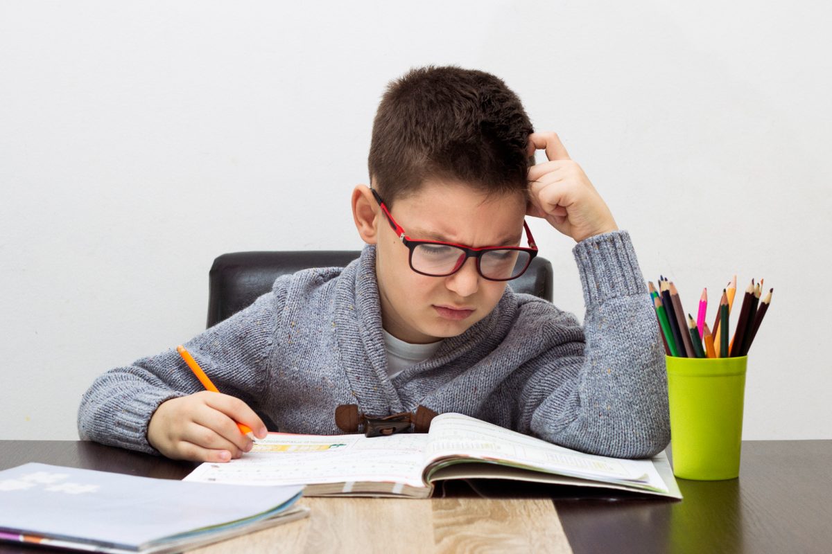 Boy struggling with homework